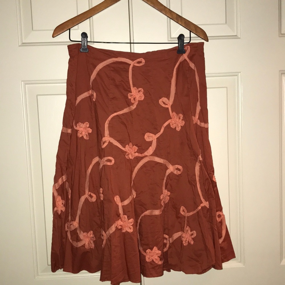 burnt orange skirt with light pink ribbon detail